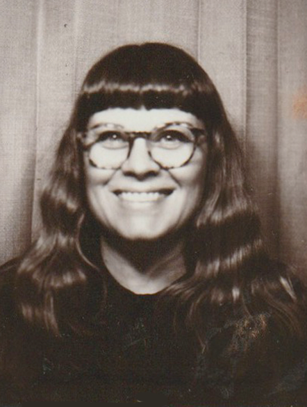 A woman with a short fringe and glasses